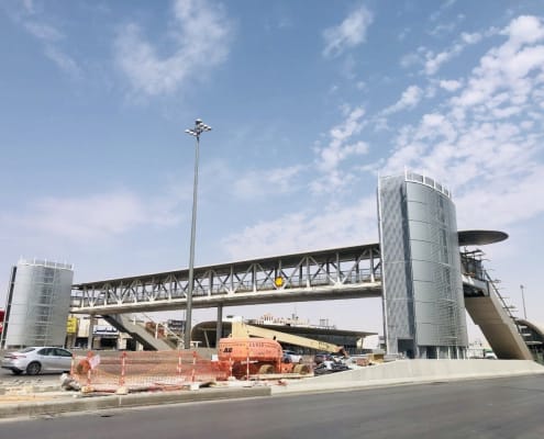Pedestrian bridge stations with metallic facade cladding