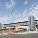 Pedestrian bridge stations with metallic facade cladding