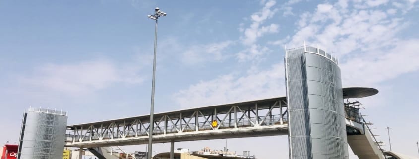 Pedestrian bridge stations with metallic facade cladding